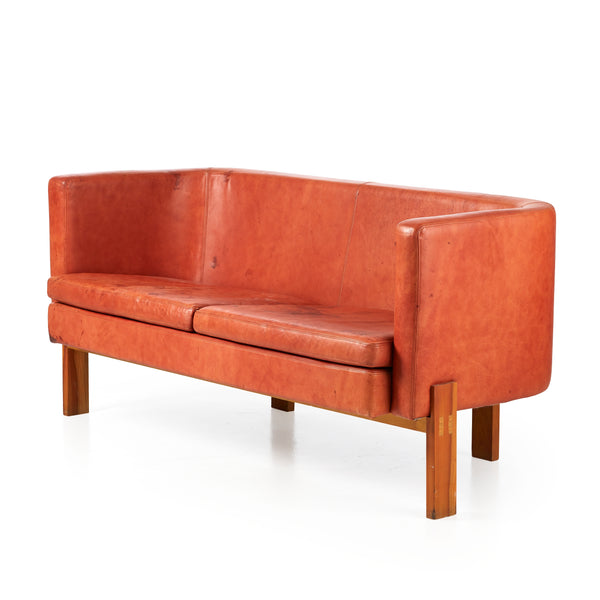 Erik Karlström : Leather Sofa in Terracotta. Cushioned back with two upholstered seat pillows. Legs in walnut.  
