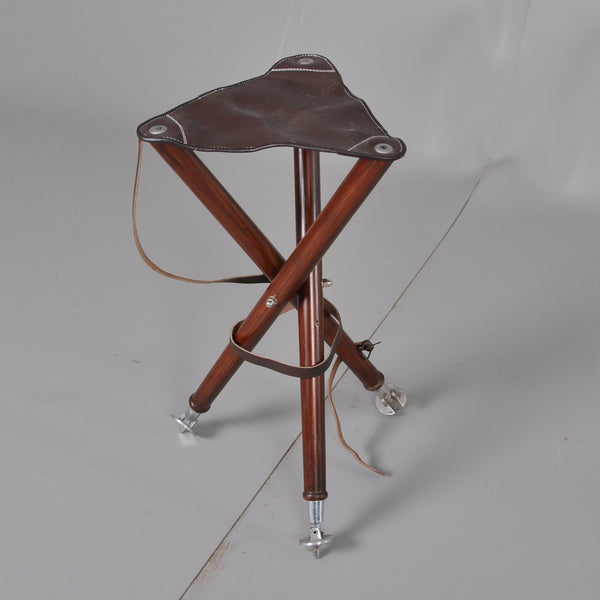 Foldable Hunting Chair in heavy brown leather, Three legs in brown stained wood. Leather carrying strap.